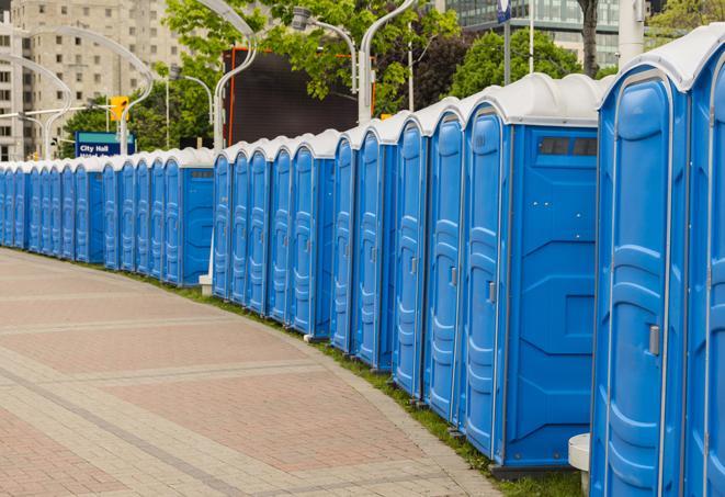 a row of sleek and modern portable restrooms at a special outdoor event in Blue Springs